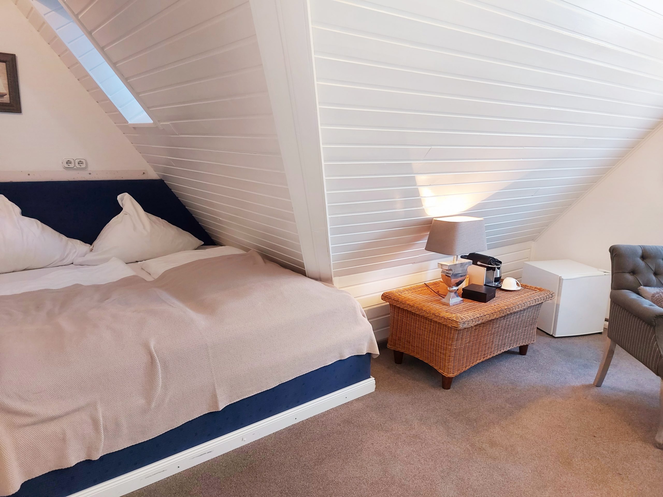 Gemütliches Wohn- Schlafzimmer mit Doppelbett im Hotel Landhaus Sylter Hahn in Westerland.