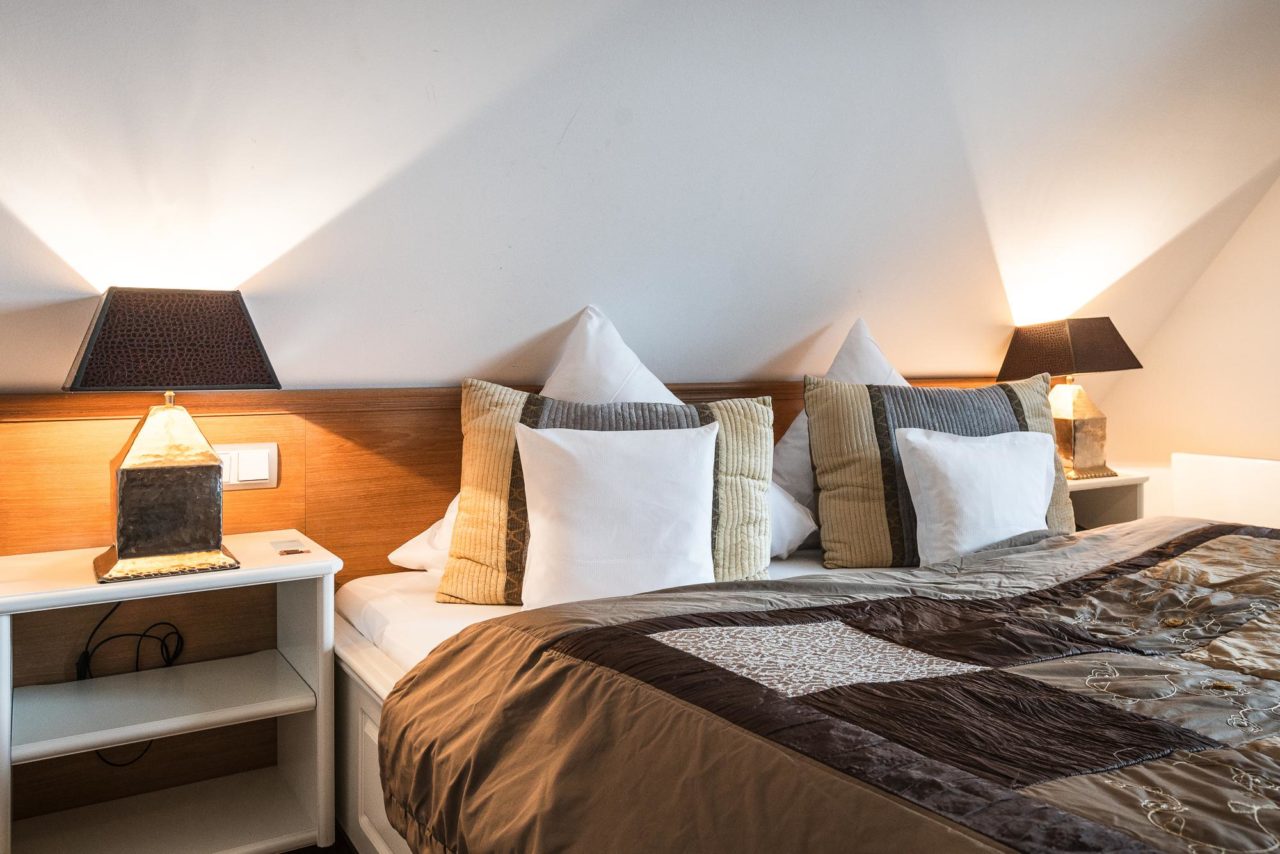 Modernes Doppelzimmer mit Doppelbett, zwei Nachttischen im Hotel Landhaus Sylter Hahn in Westerland.